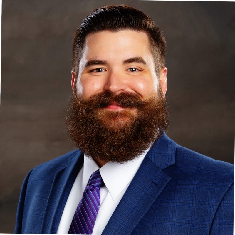 Headshot of man with brown hair and beard